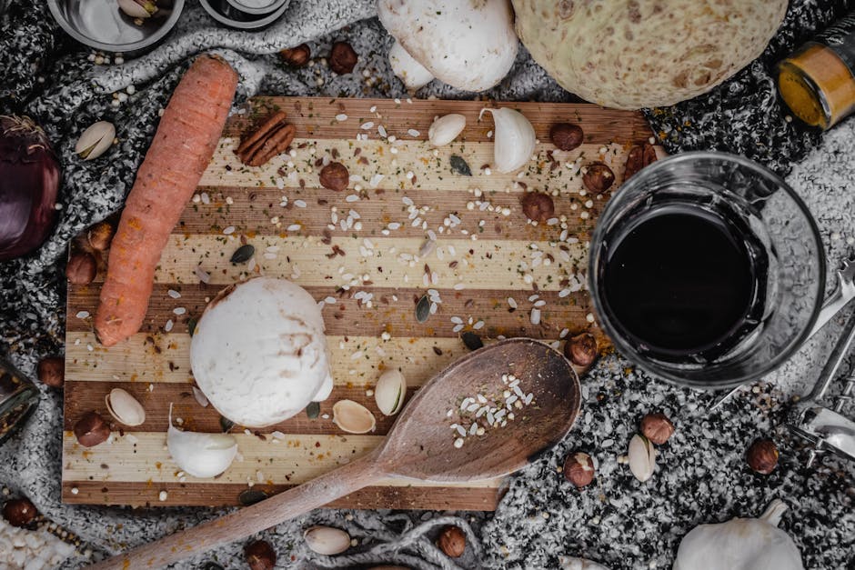 A rustic flat lay of assorted kitchen ingredients on a wooden board, perfect for culinary themes.